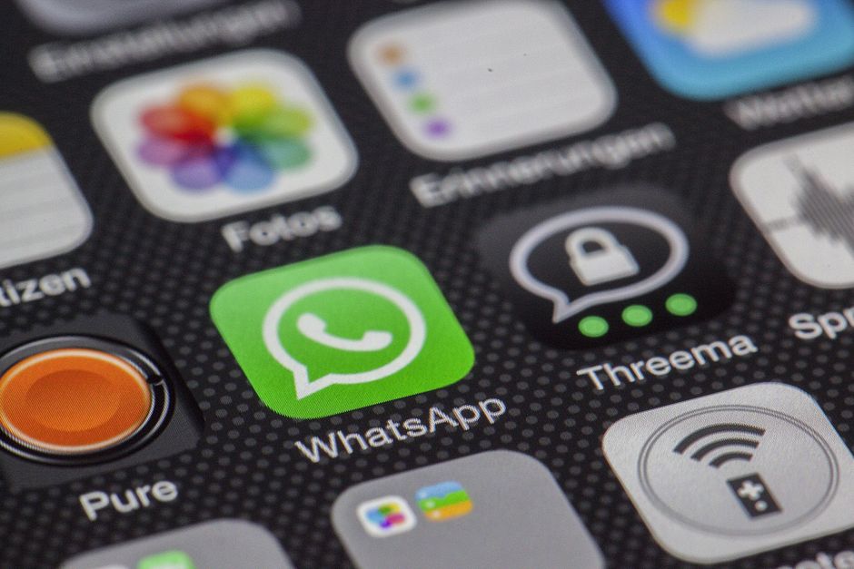 Detailed macro of smartphone screen showcasing popular app icons like WhatsApp.